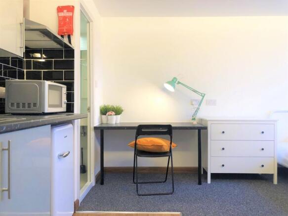 Bright and tidy single bedroom featuring a prac...