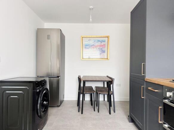 Modern kitchen with dining area and sleek units...