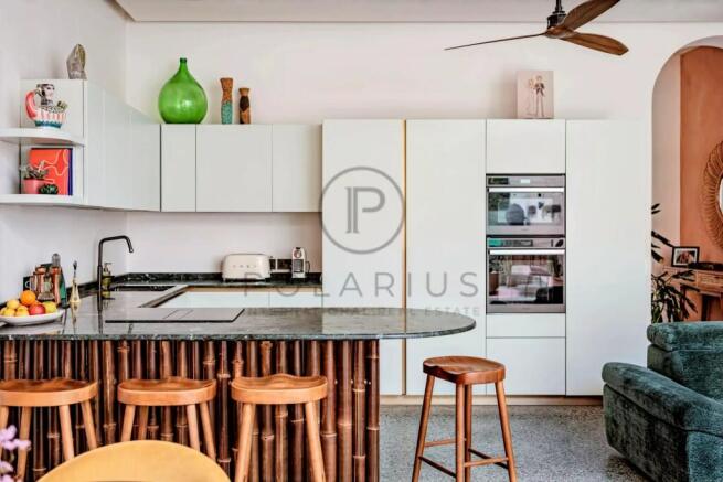 Modern kitchen with sleek white cabinetry and a st