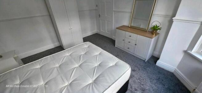Bright bedroom with stylish furniture and stora...