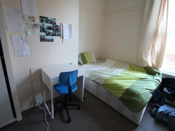 A spacious double bedroom featuring a double be...