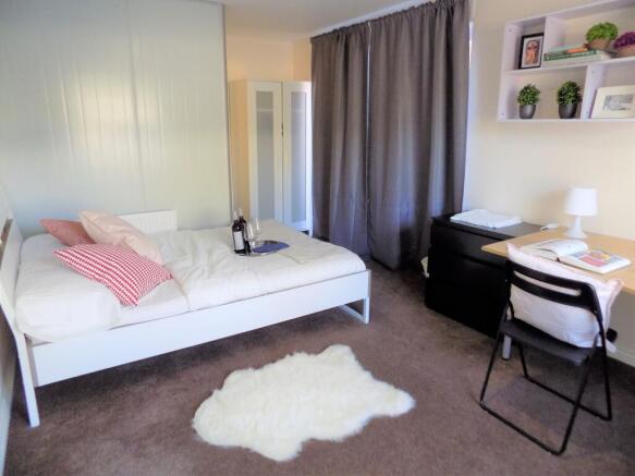 Bright, tidy double bedroom with a white bed, c...