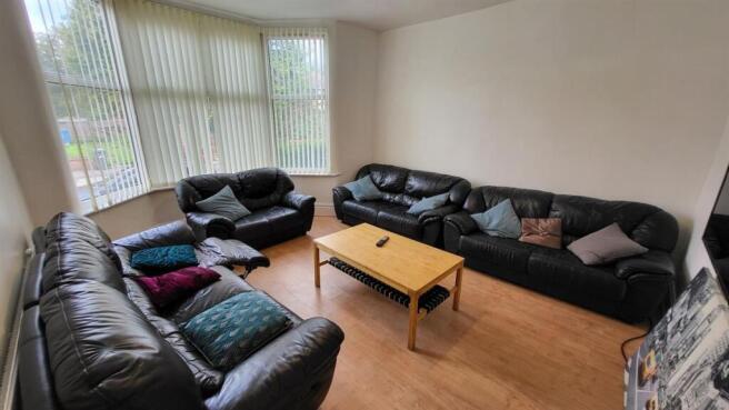 Spacious living room with bright bay window...