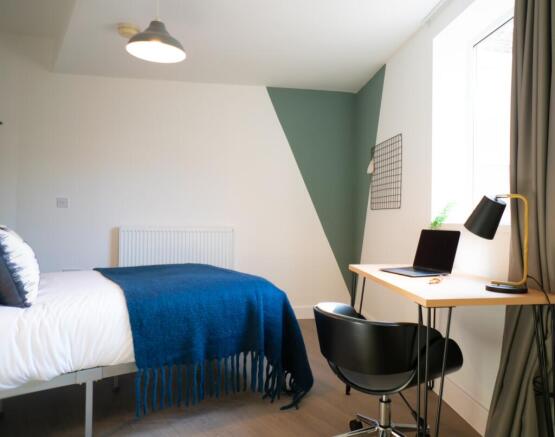 A bright and modern double bedroom featuring a ...