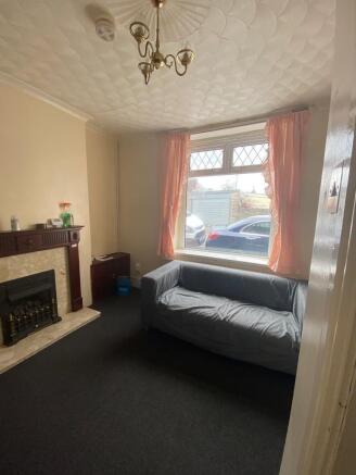 Cosy lounge with feature fireplace and window...