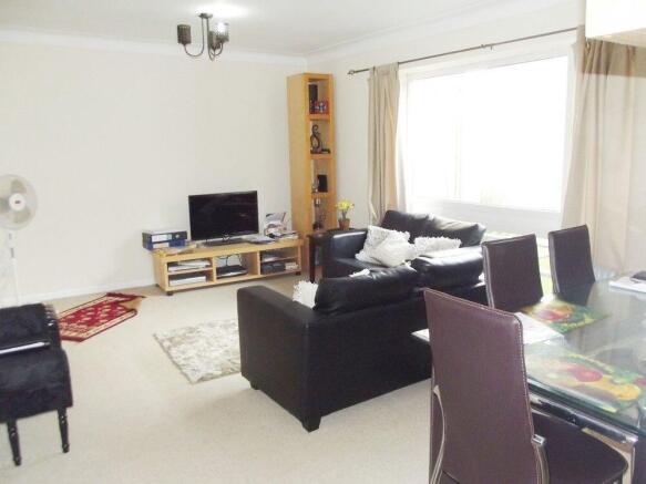 Bright and spacious living room with dining are...
