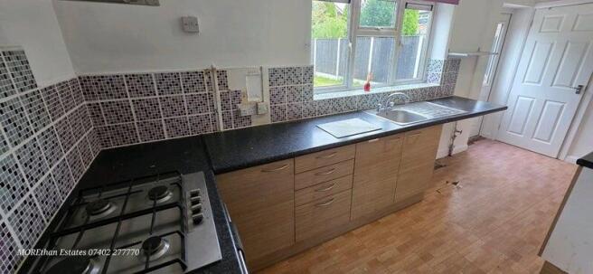 Bright galley kitchen with long worktop...