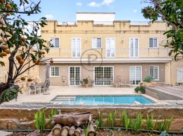 A serene backyard view with a swimming pool, surro