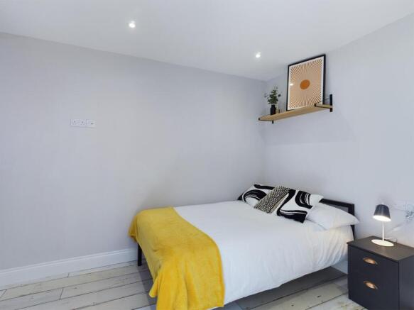 A bright and inviting double bedroom featuring ...