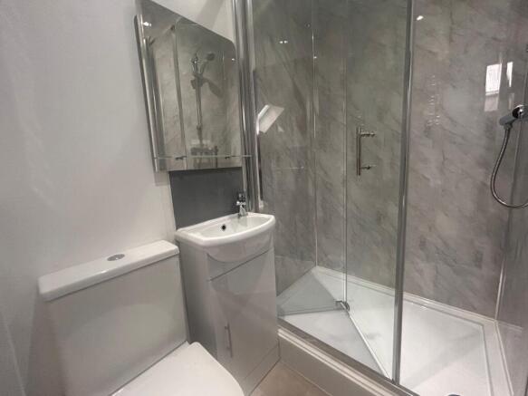 Modern bathroom with glass shower and vanity...