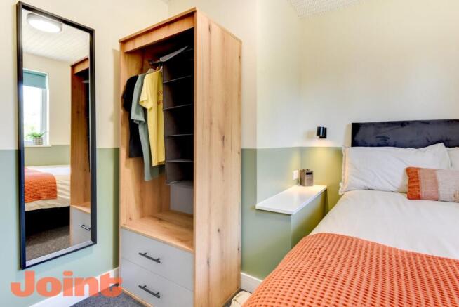 Bright, modern bedroom featuring a comfortable ...