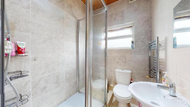 Bright, modern bathroom with a glass shower enc...