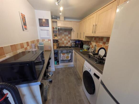 Bright kitchen with modern integrated appliance...