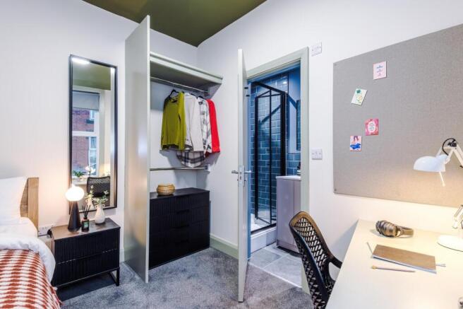 Bright, modern double bedroom with built-in war...