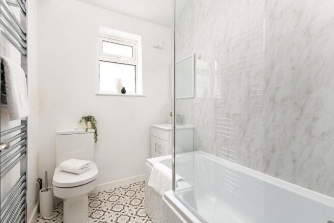 Elegant bathroom with marble tiles and tub...