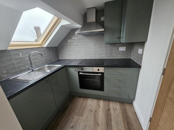 Modern compact kitchen with L-shaped dark count...