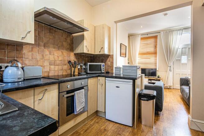 Bright modern kitchen with integrated appliance...