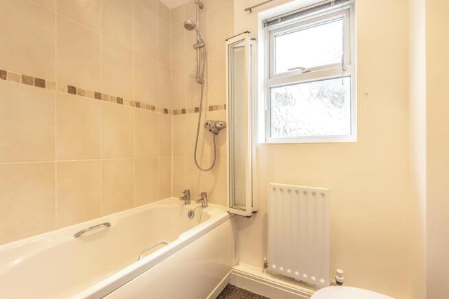 Bathroom with separate shower over