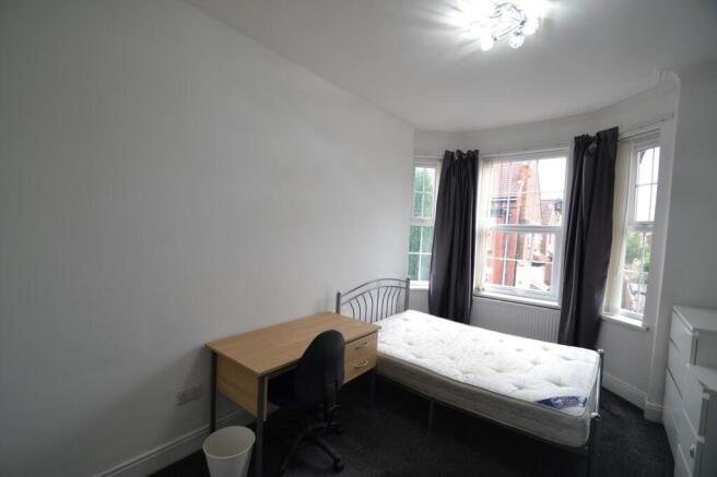 A bright, well-maintained bedroom featuring a s...