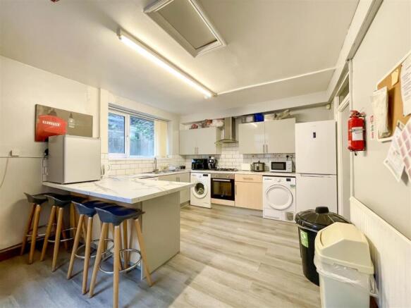 Bright kitchen with breakfast bar and appliance...