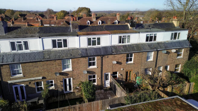 Elevated view over the house showing open countryside and walks beyond
