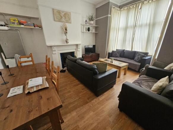 A welcoming and well-lit living room with ample...