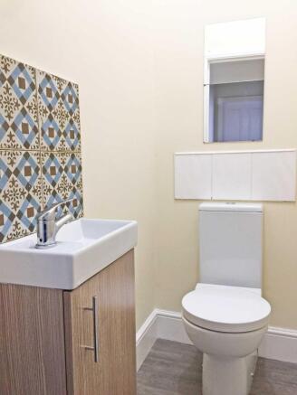 Bright, tidy WC with a modern basin and vanity ...