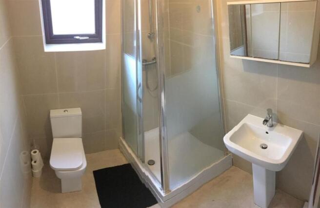 Bright modern shower room with sleek tiling...