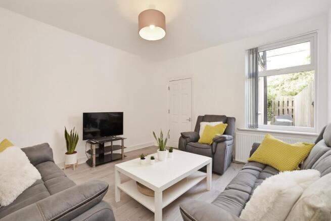 Bright, modern living room with comfortable gre...