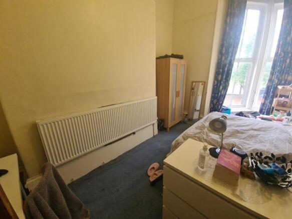 Bright and cozy double bedroom featuring a larg...