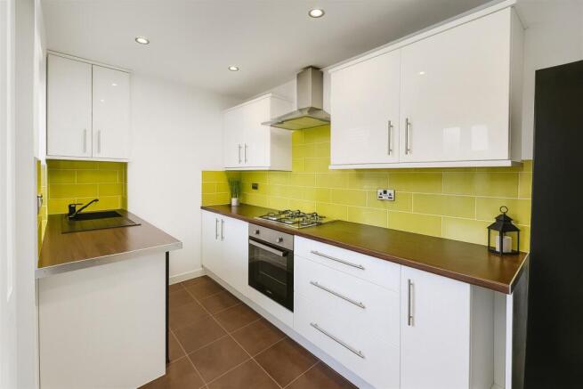 Bright modern kitchen with white high-gloss cab...