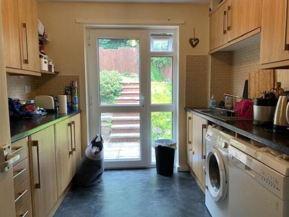 Bright galley kitchen with garden access...