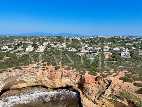Clifftop coastal view with luxury villa at the ocean in Carvoeiro Algarve