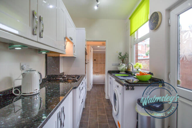Granite kitchen with door to gardens