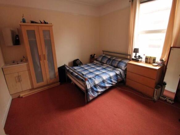 A comfortable double bedroom featuring a double...