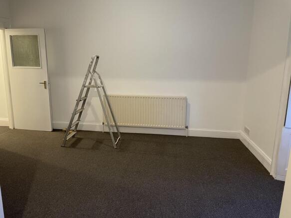 Bright, freshly painted living room with neutra...