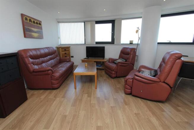 Bright lounge with comfy leather sofas and view...
