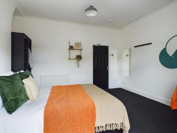 A spacious and inviting double bedroom with mod...