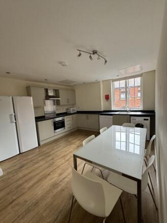 Bright shared kitchen with modern fitted units,...