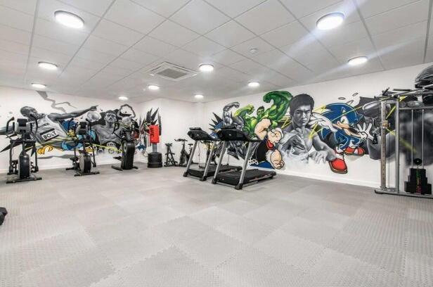Modern gym room featuring a variety of exercise...