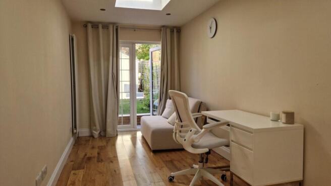 Bright study area with desk and garden access...