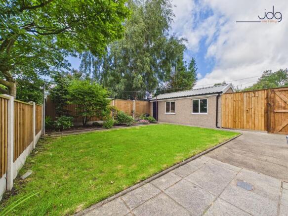 Private lawned garden with patio and mature planting