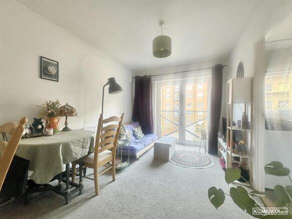 Bright lounge with dining area and balcony acce...