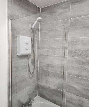 Modern electric shower with sleek grey tiling...