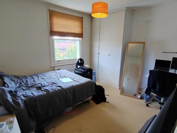 Bright bedroom with built-in storage and desk...