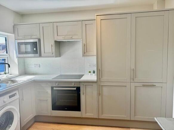 Modern kitchen with sleek cabinetry and applian...