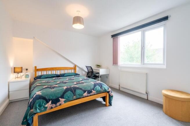 Bright and welcoming bedroom featuring a double...