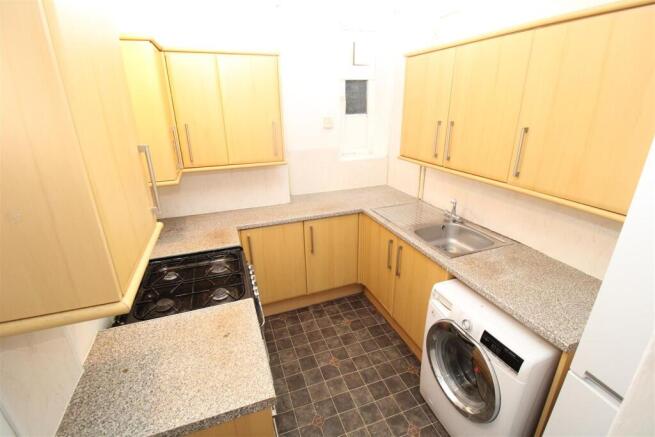 Bright kitchen with ample storage and appliance...
