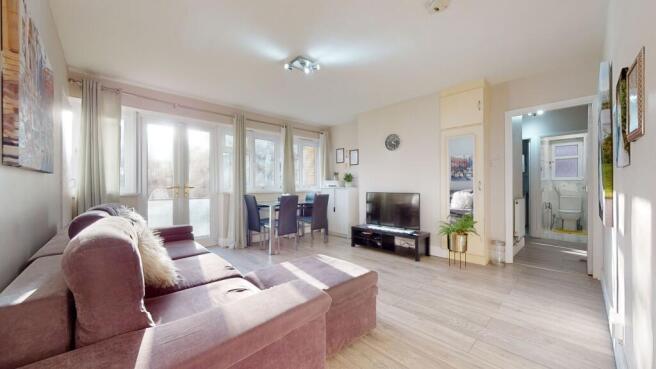 Bright, modern living room with large windows a...