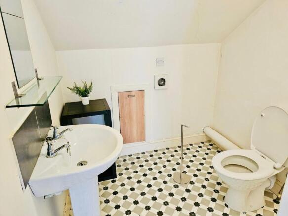 Bright and clean bathroom with a white sink, to...